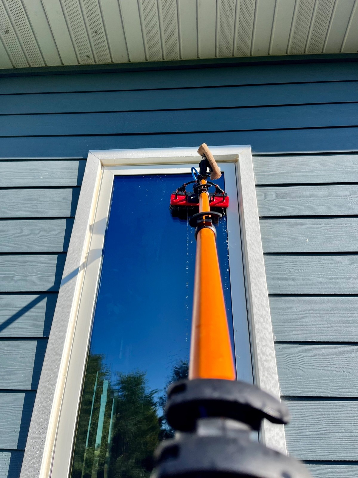 Strong Window Cleaning technician cleaning exterior glass in Grand Island, NE